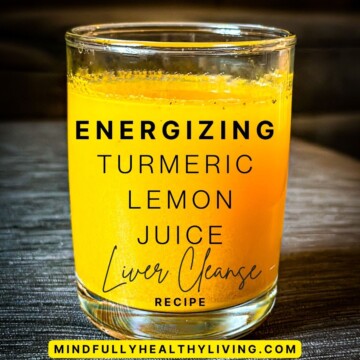 A closeup photo of a bright orange and yellow drink in a glass cup. In text overlay is says energizing turmeric lemon juice liver cleanse recipe mindfullyhealthyliving.com