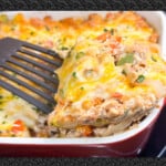 keto chicken fajitas with melted cheese on top is being scooped from a red baking dish with a black serving spatula.