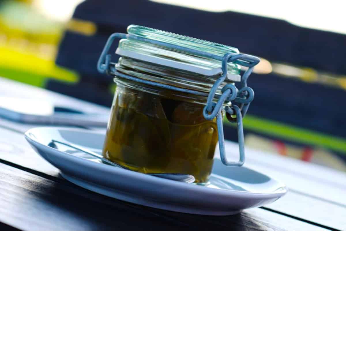 a jar of homemade pickles on a plate