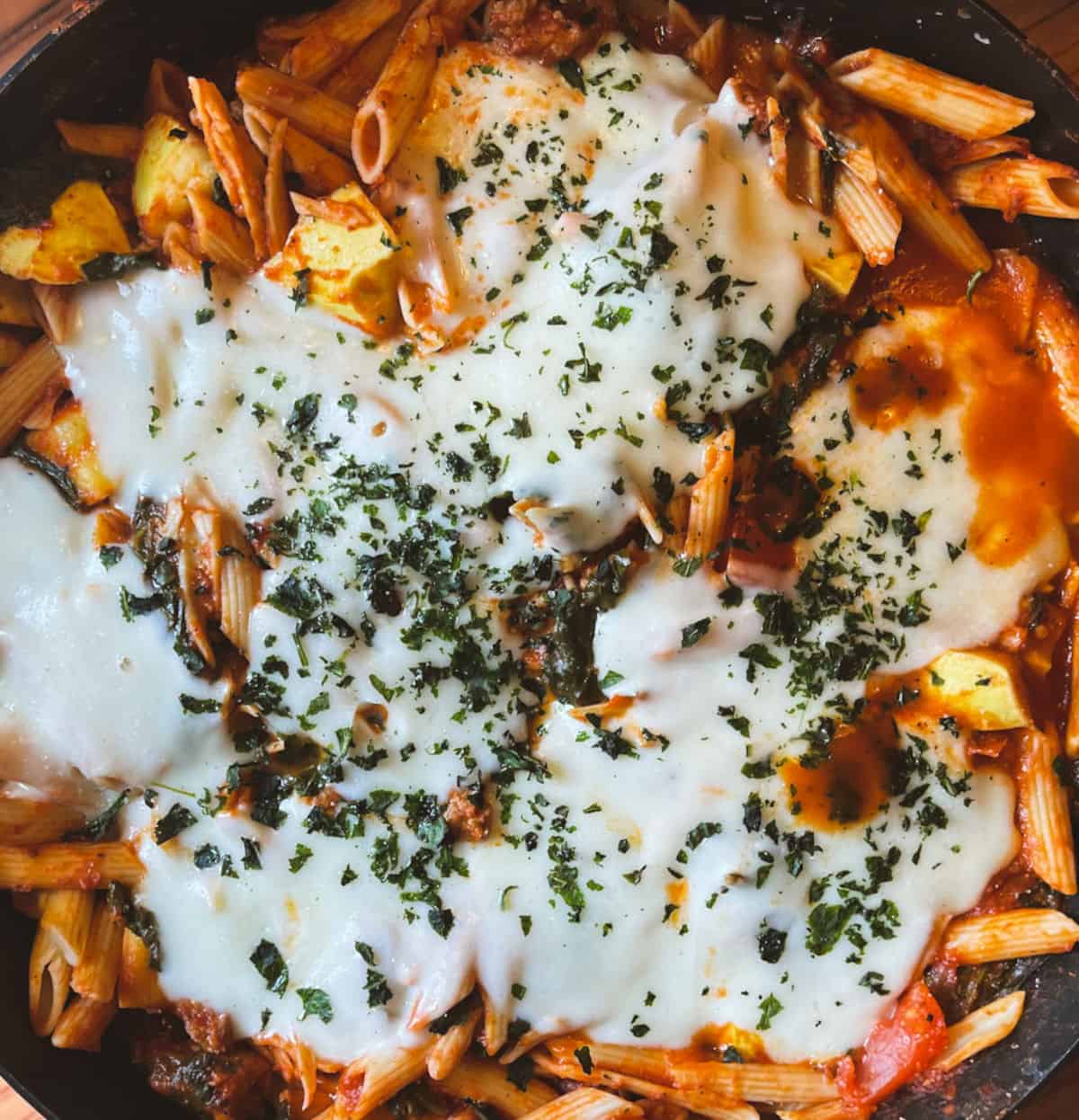 spinach and sausage skillet with melted fresh mozzarella and basil