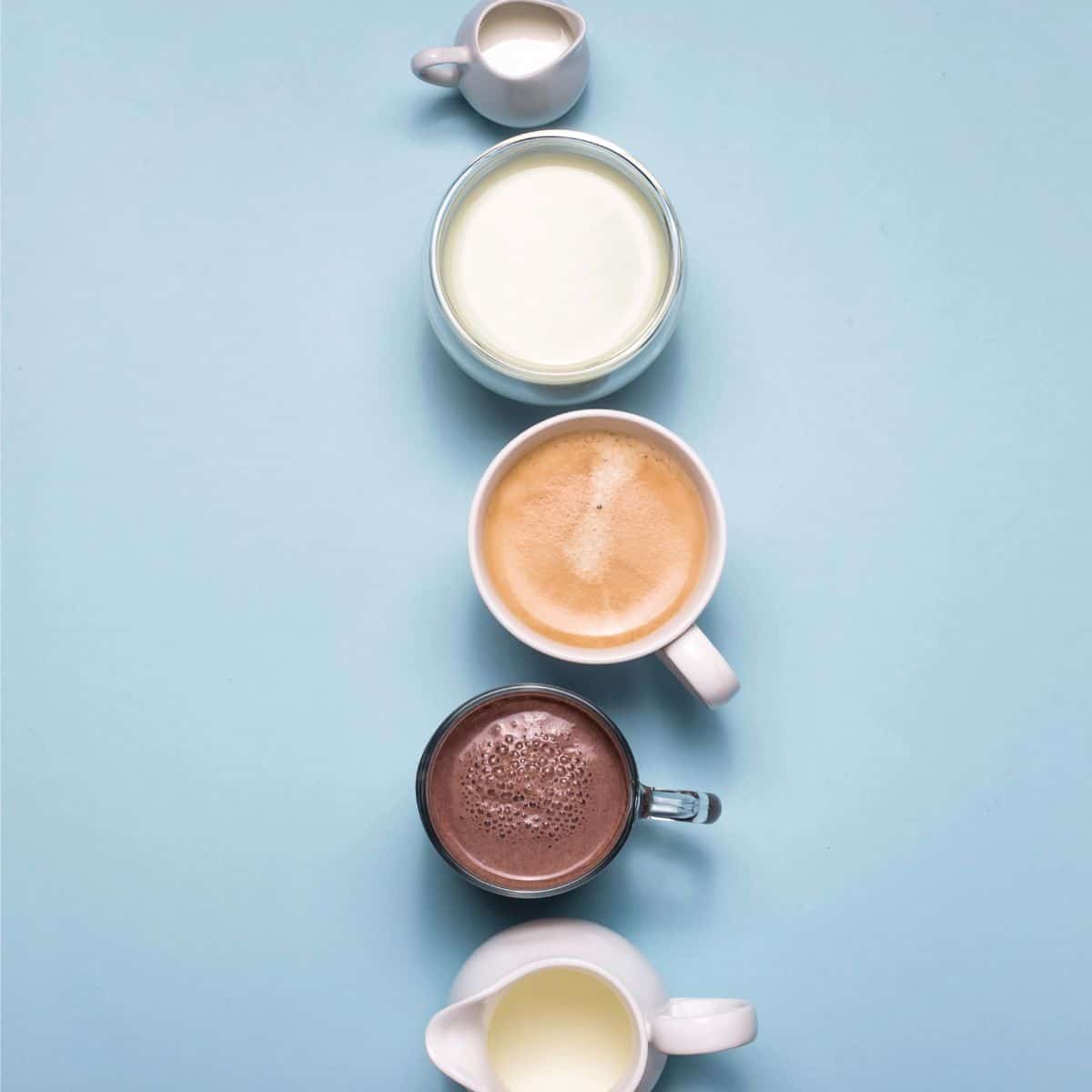 5 differently shaped cups with different types of coffee creamers in them lined up from top to bottom with a light blue background.
