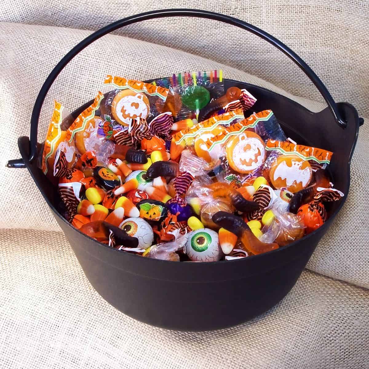 A black bucket of traditional Halloween candy