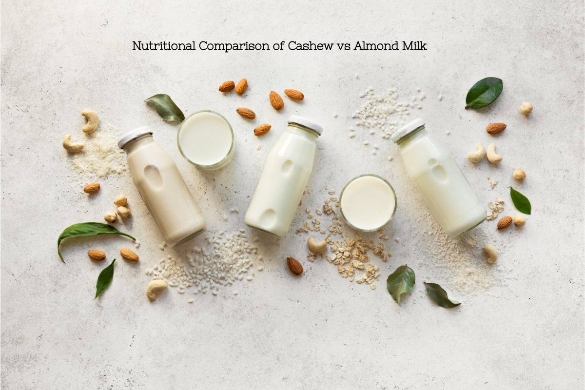 A light background with 3 jars of different plant milks in glass jars surrounded by various almonds, cashews, seeds, and oats. The text overlay says a nutritional comparison of cashew vs almond milk.