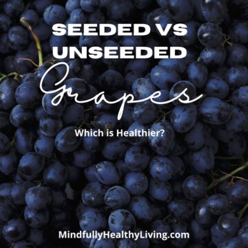 a background of deep purplish-blue grapes with white text overlay that says seeded vs unseeded grapes which is healthier? mindfullyhealthyliving.com