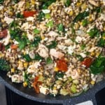 Trader Joe's Harvest Blend Chicken and Spinach Stir-Fry in a pan, ready to serve.