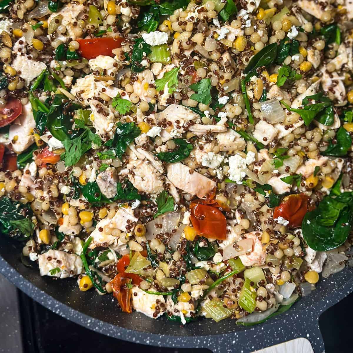 Overhead shot of Trader Joe's Harvest Blend Chicken and Spinach Stir-Fry in a pan, ready to serve.