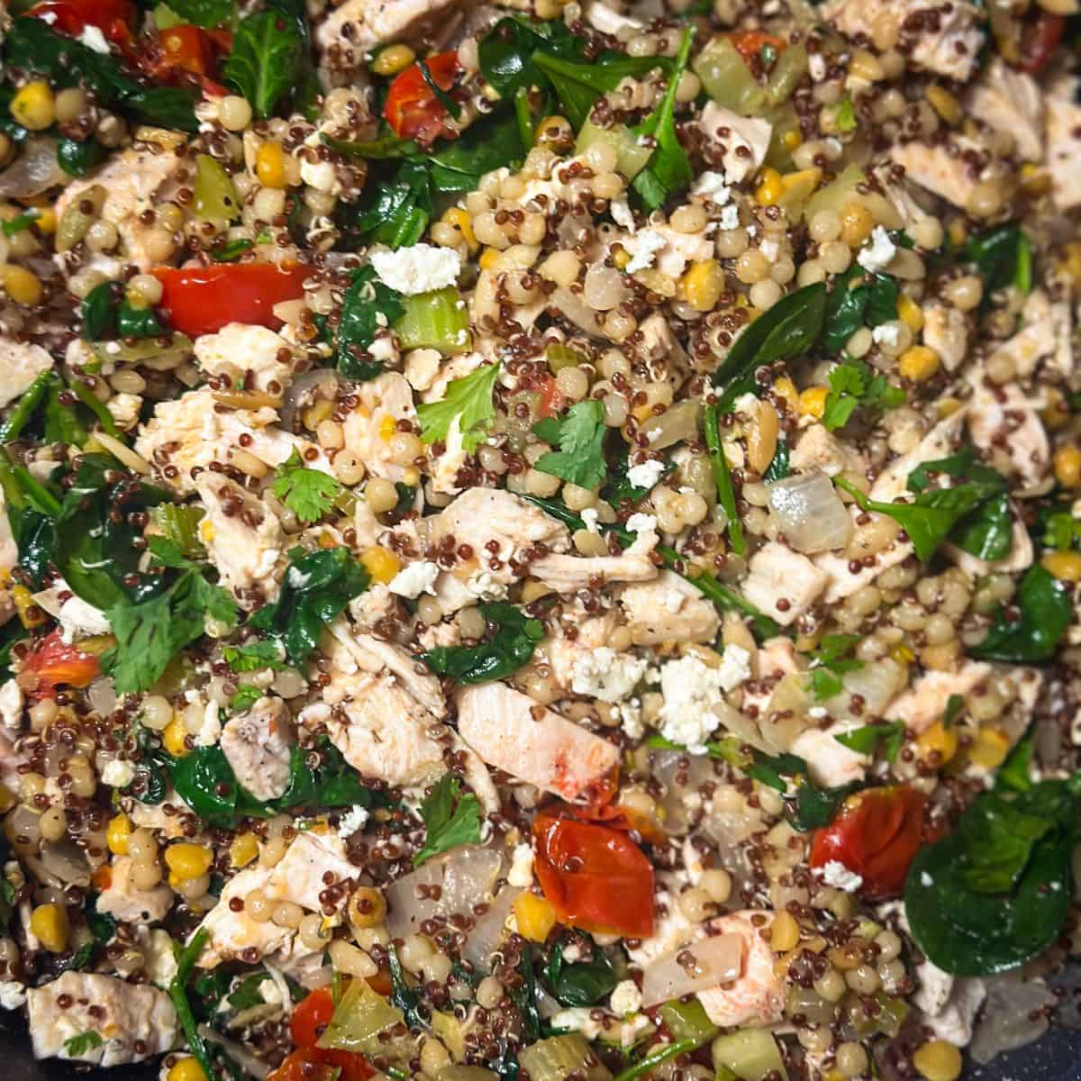 Close-up of the finished stir-fry dish topped with crumbled feta and fresh cilantro.
