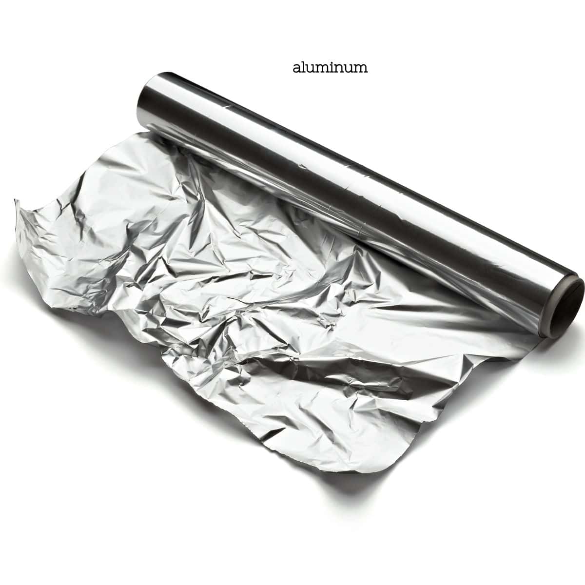 A roll of aluminum foil partially unrolled, representing materials to avoid when cooking due to potential health risks.