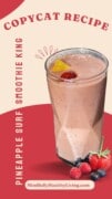 A tan and red-themed photo with a picture of a pink smoothie garnished with fruit on top and berries at the foot of it. The text overlay says copycat recipe and on the side text running up says pineapple surf smoothie king. at the bottom it says mindfullyhealthyliving.com