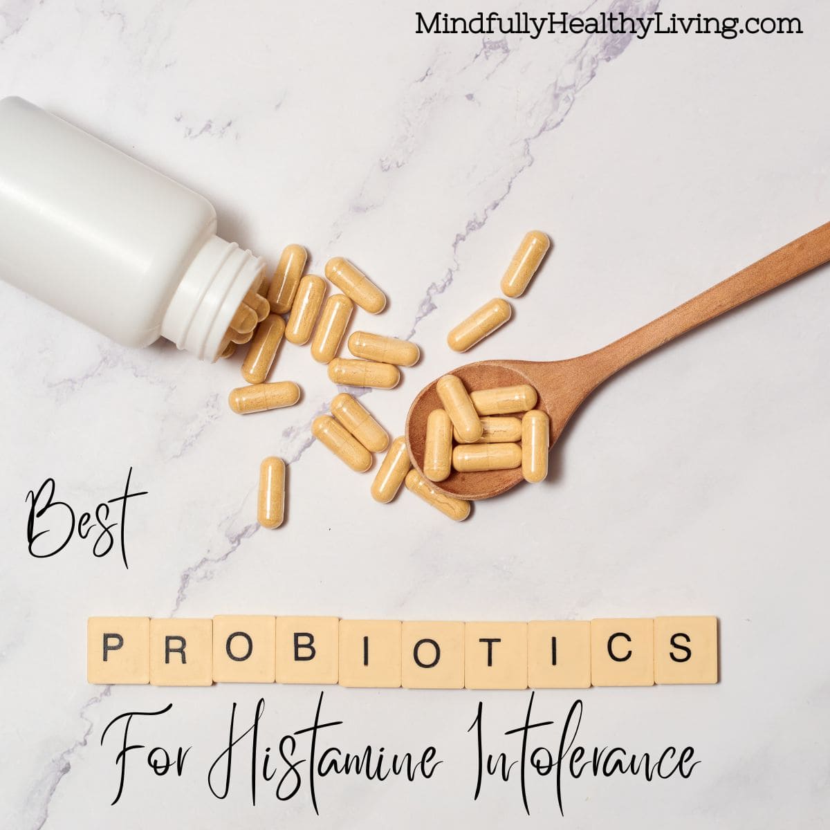 Image of a bottle of capsules spilled onto a marble surface with a wooden spoon; the text reads "Best Probiotics For Histamine Intolerance - MindfullyHealthyLiving.com