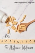 Image with capsules spilled from a bottle and placed on a wooden spoon; the text reads "Best Probiotics For Histamine Intolerance - MindfullyHealthyLiving.com," suited for a Pinterest post.