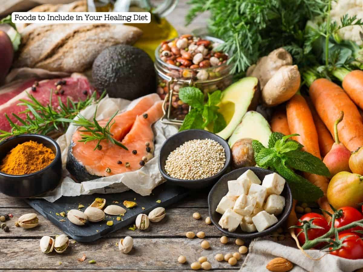 A diverse selection of whole foods including salmon, avocado, carrots, tomatoes, nuts, and seeds on a rustic wooden table, highlighting the variety of healthy options for post-surgery nutrition.