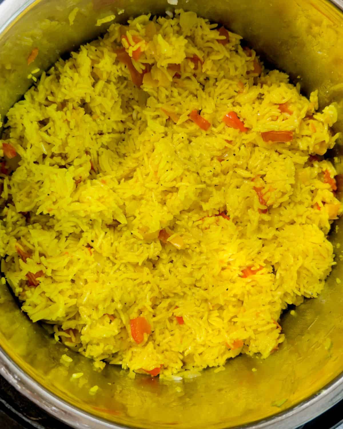 Fluffy, yellow saffron rice in an Instant Pot, hinting at the fragrant spices used in its preparation.