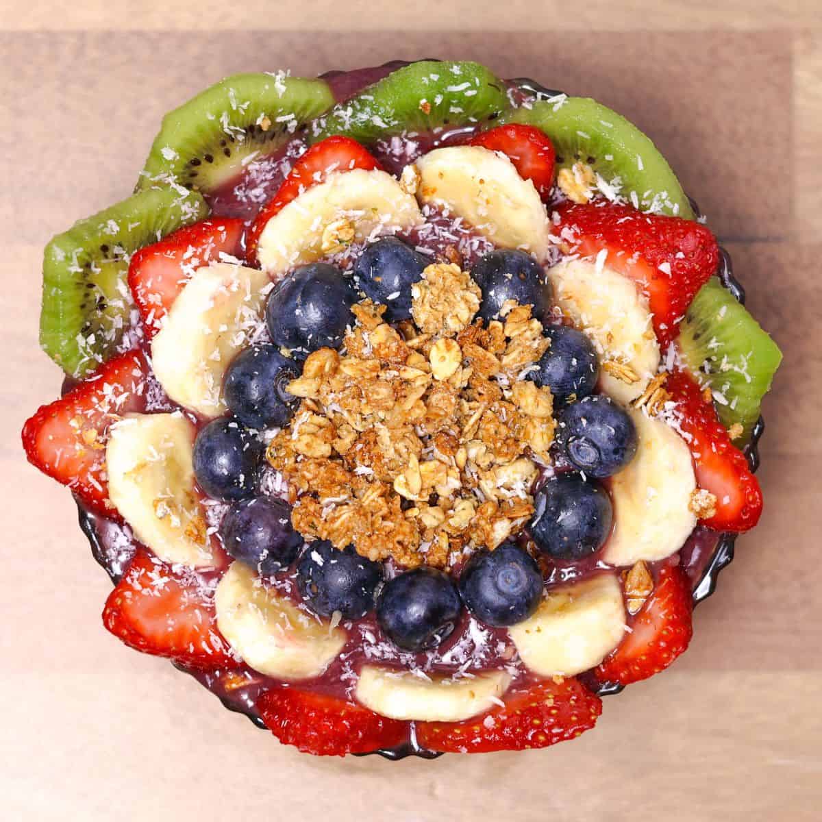 A finished Hawaiian açaí bowl with a colorful arrangement of banana, kiwi, strawberries, and blueber