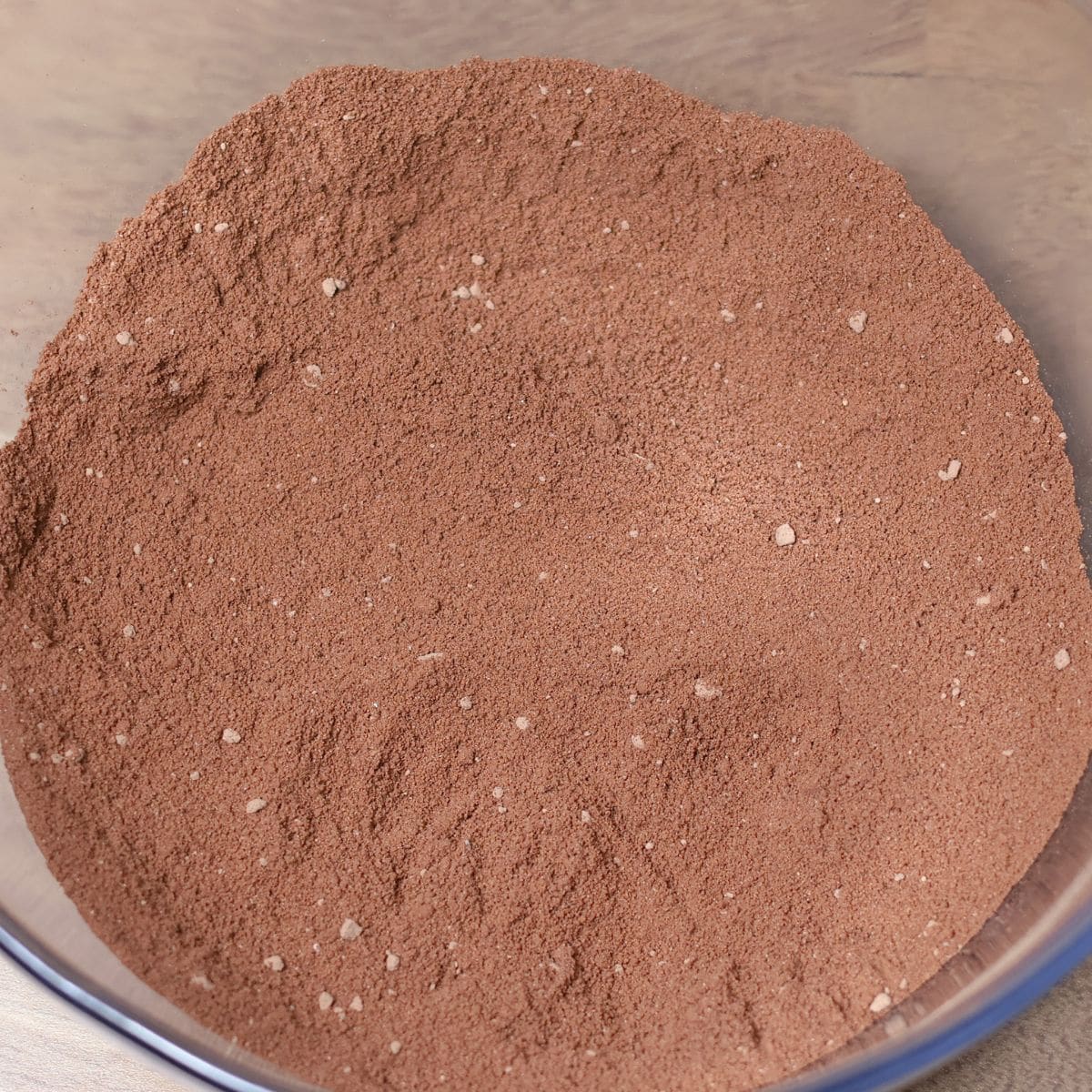 Almond flour, cacao powder, and fine sea salt combined in a bowl, ready for the wet ingredients.