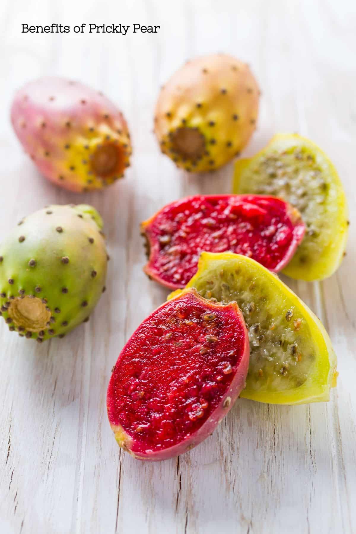 Red and yellow prickly pear fruit cut open to show the juicy inner fruit.