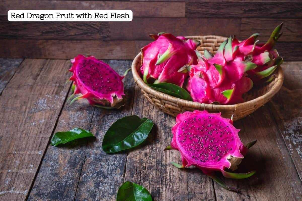 A bowl of red dragon fruit cut open to reveal magenta flesh and black seeds.