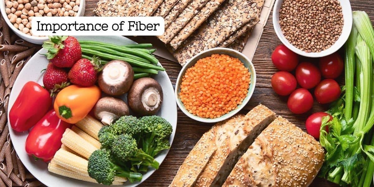 Various forms of fiber on a plate and table including vegetables, grains, seeds, fruit, nuts, psyllium husks and pasta.