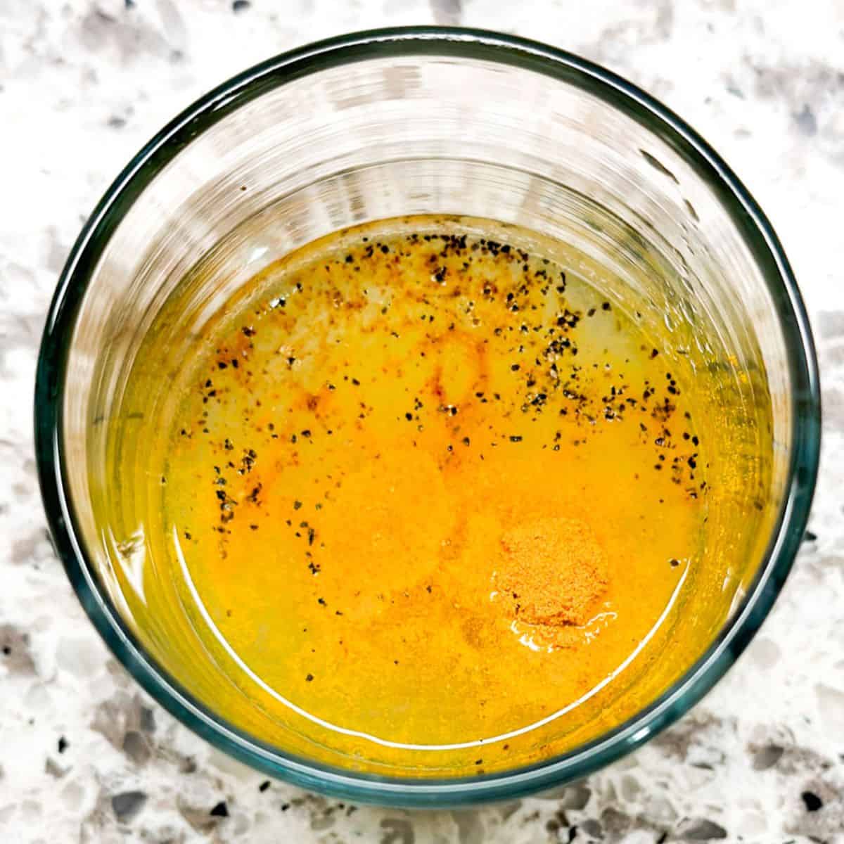 Ingredients for lemon juice cleanse added to a glass.