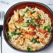 A Tuscan Chicken and Rice bowl assembled.