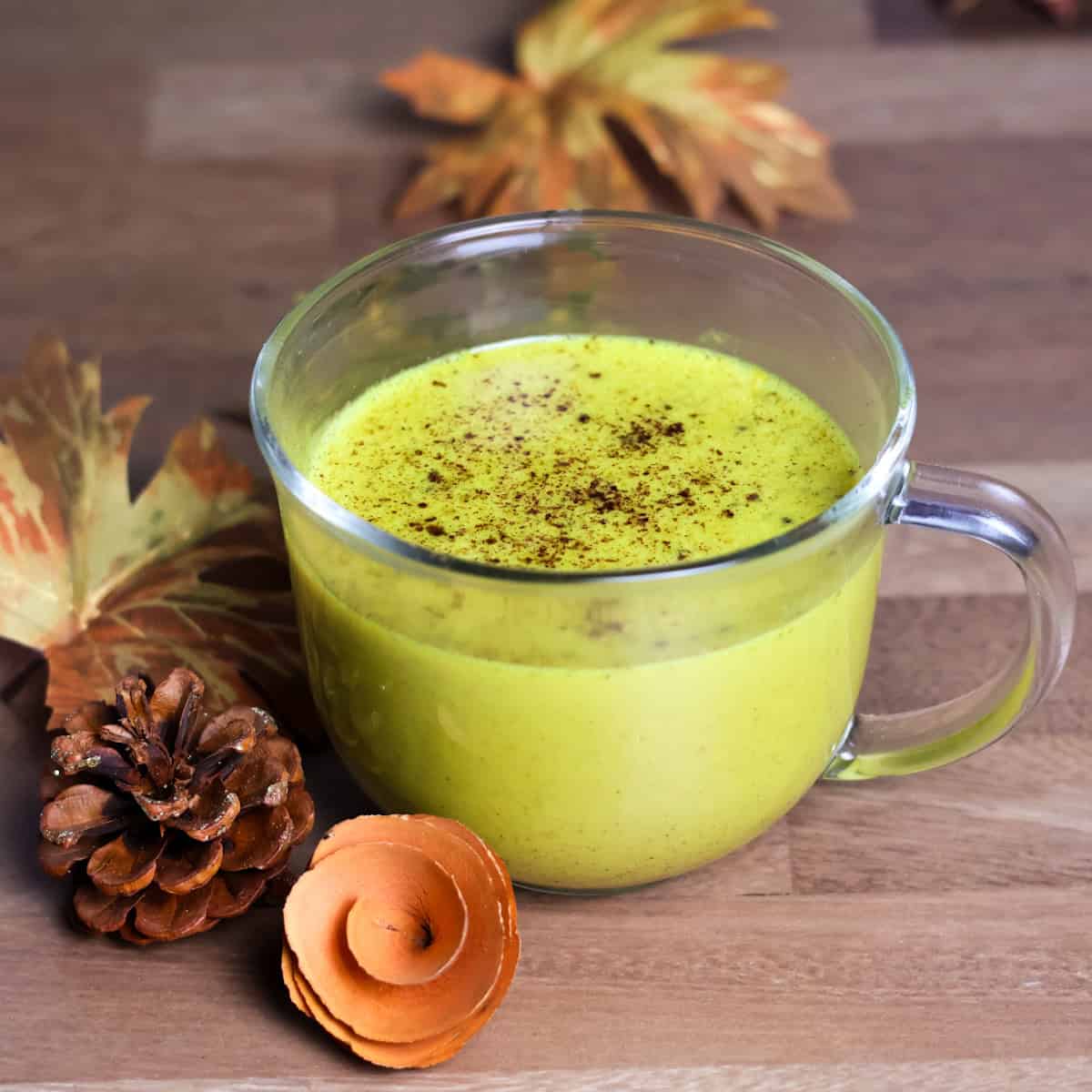 A golden milk latte garnished with sprinkled cinnamon.