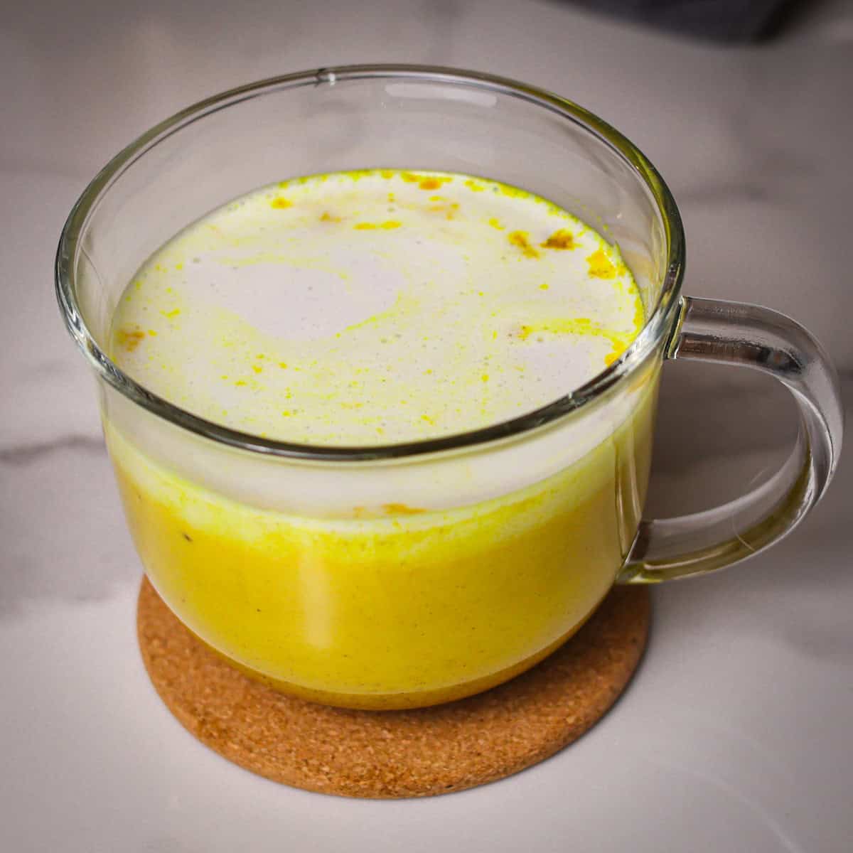 Coconut cream added to warmed golden milk.