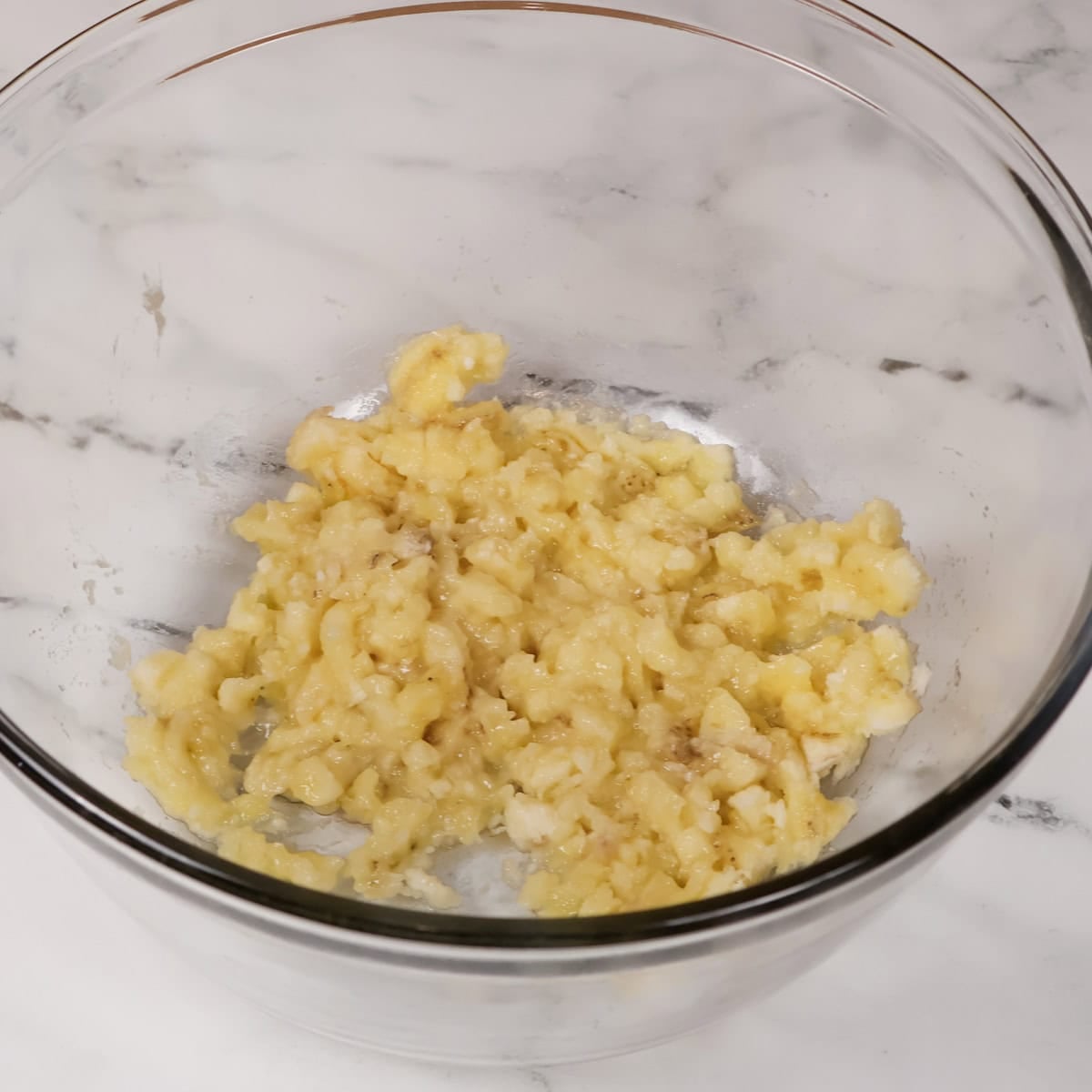 Bananas mashed in a bowl.
