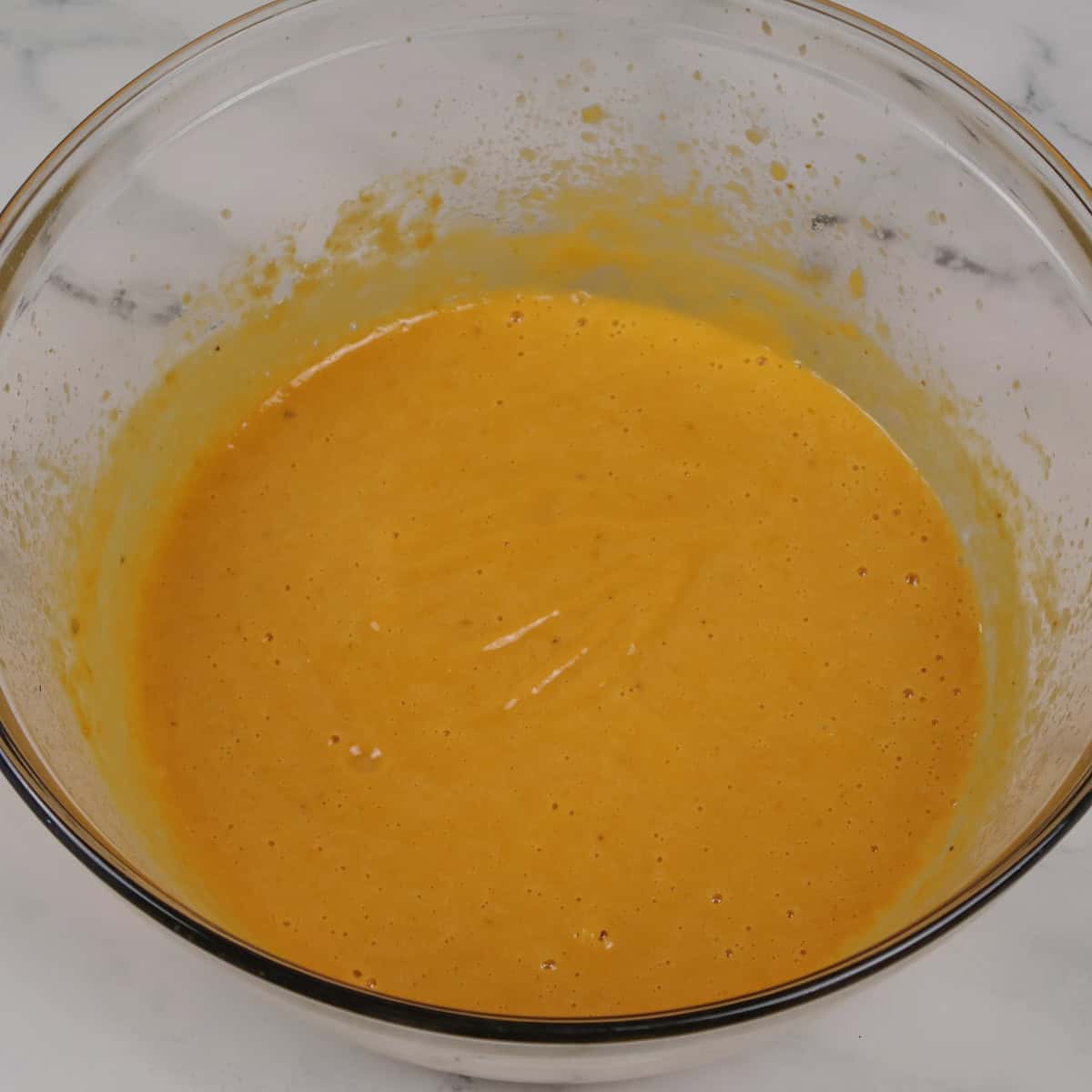 Mixed wet ingredients for the pumpkin muffins recipe.