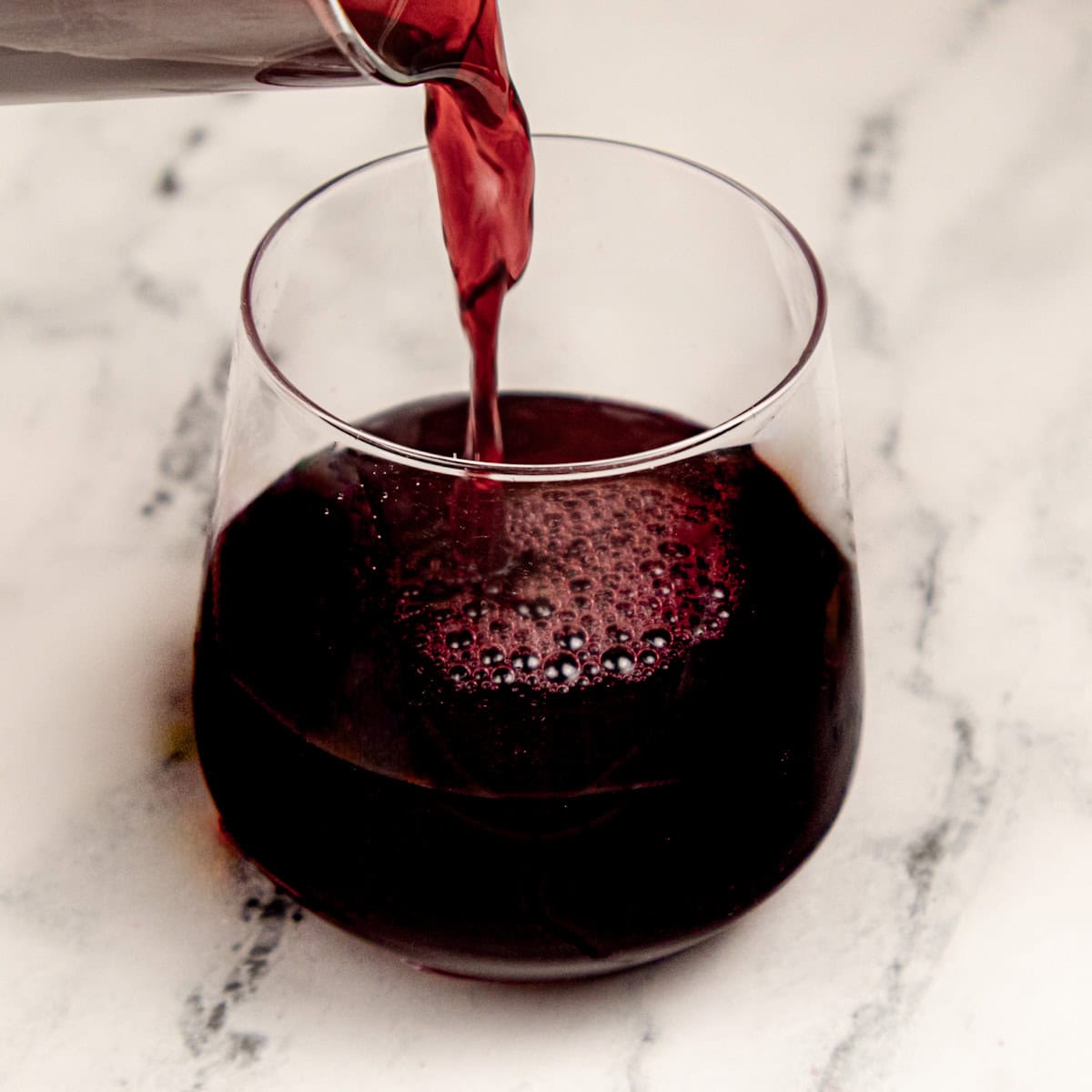 Adding coconut water an pomegranate juice to the cocktail juice.