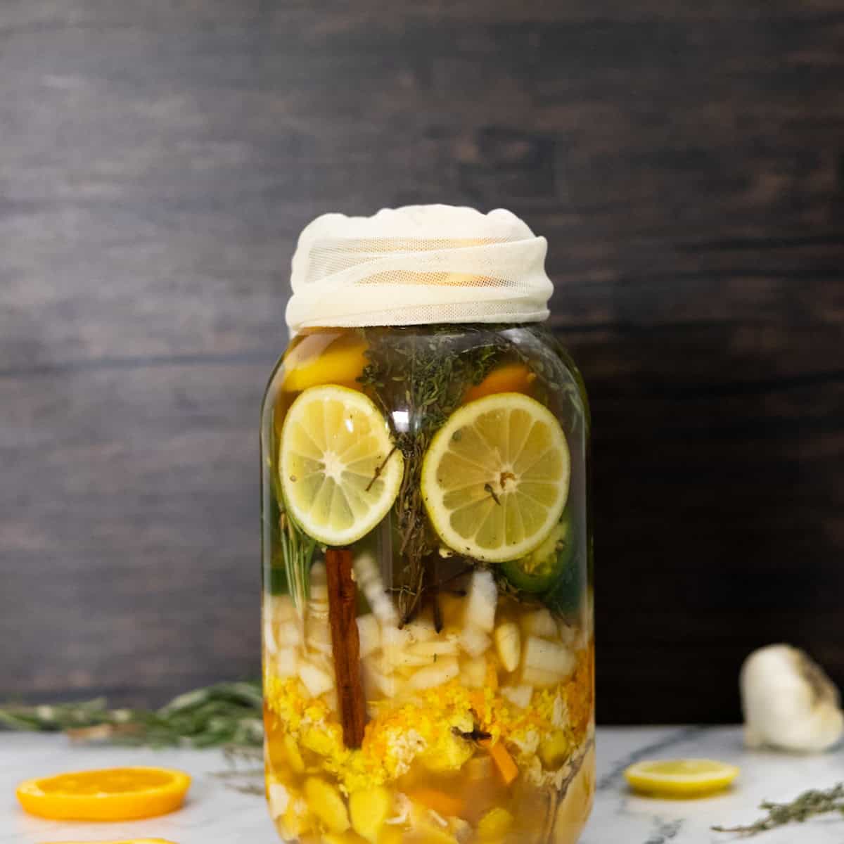 A cheese cloth over fire cider ready to strain.