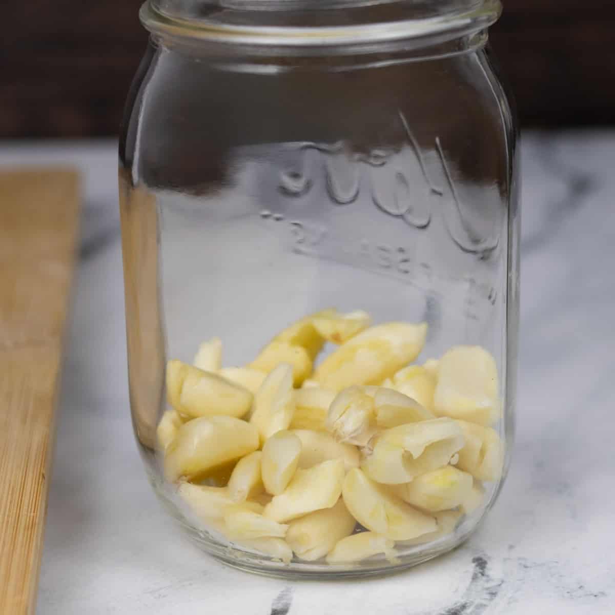 Crushed garlic cloves in a jar.