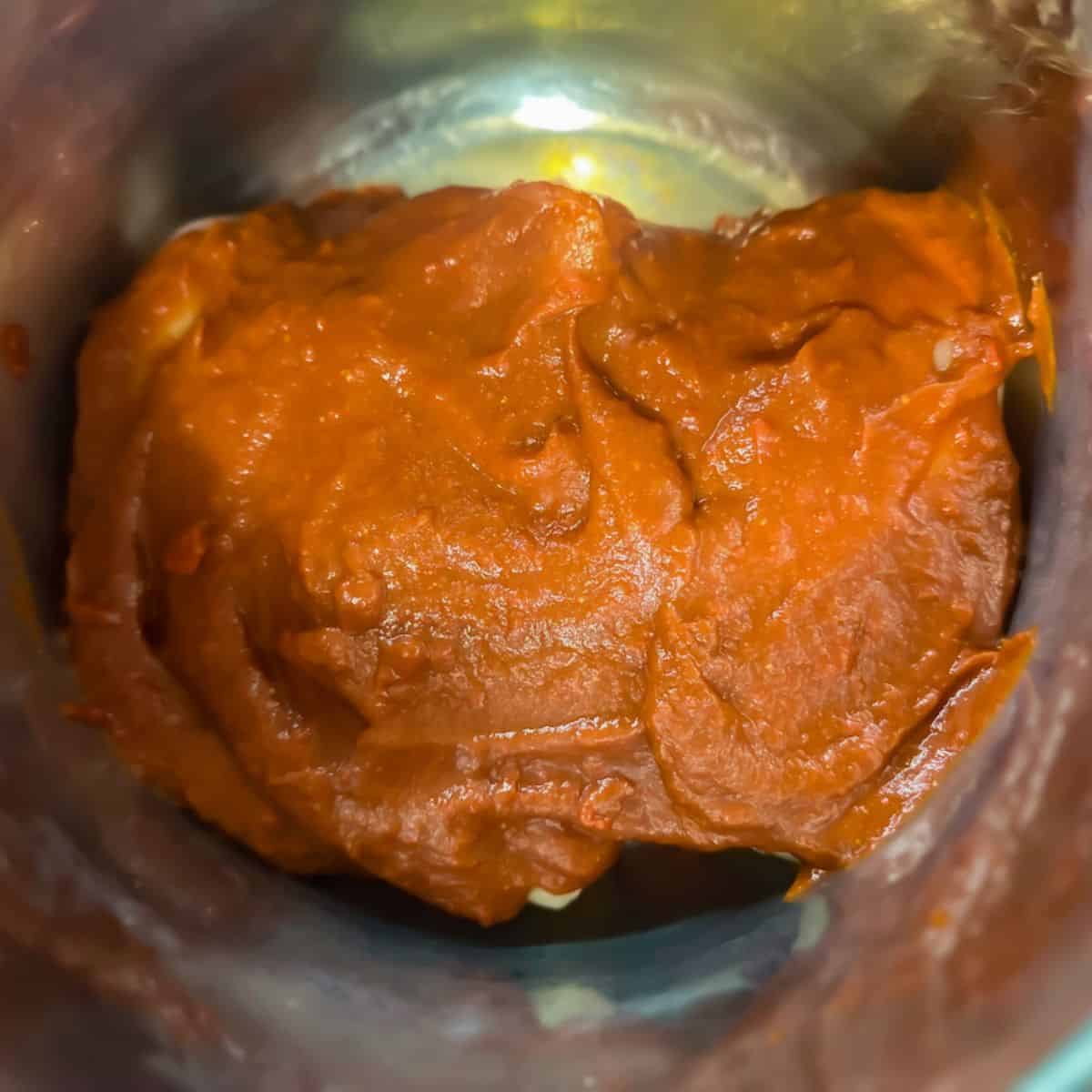 BBQ sauce covering chicken ready to cook.