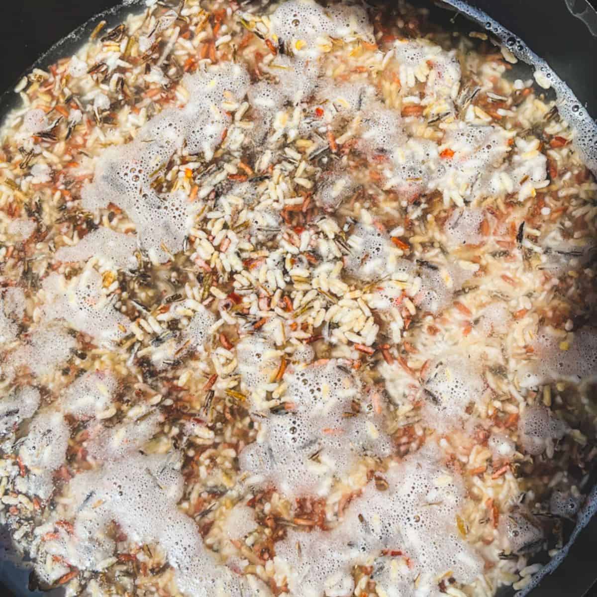 Rice cooking in water.