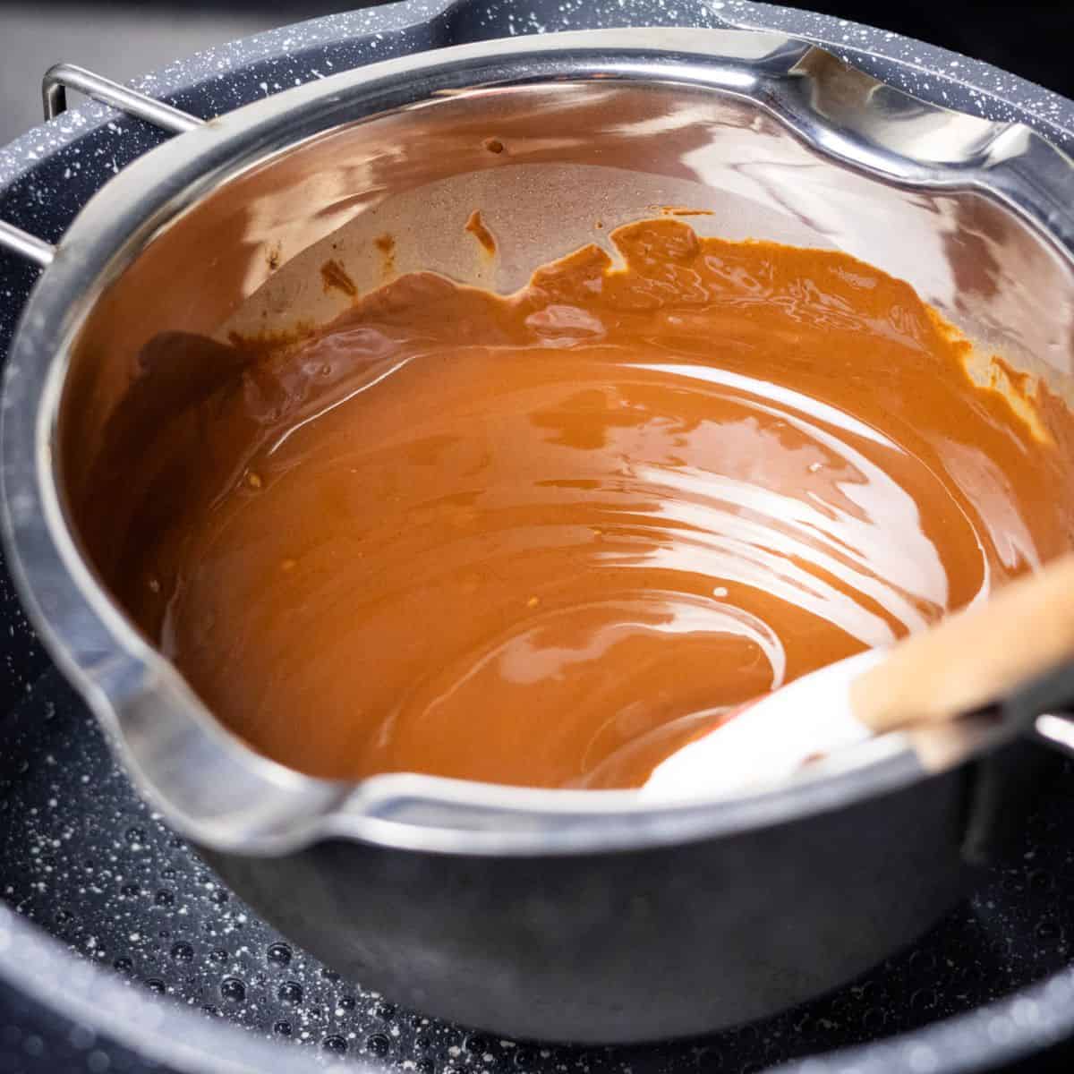 Melted chocolate and coconut oil mixture in a double boiler.